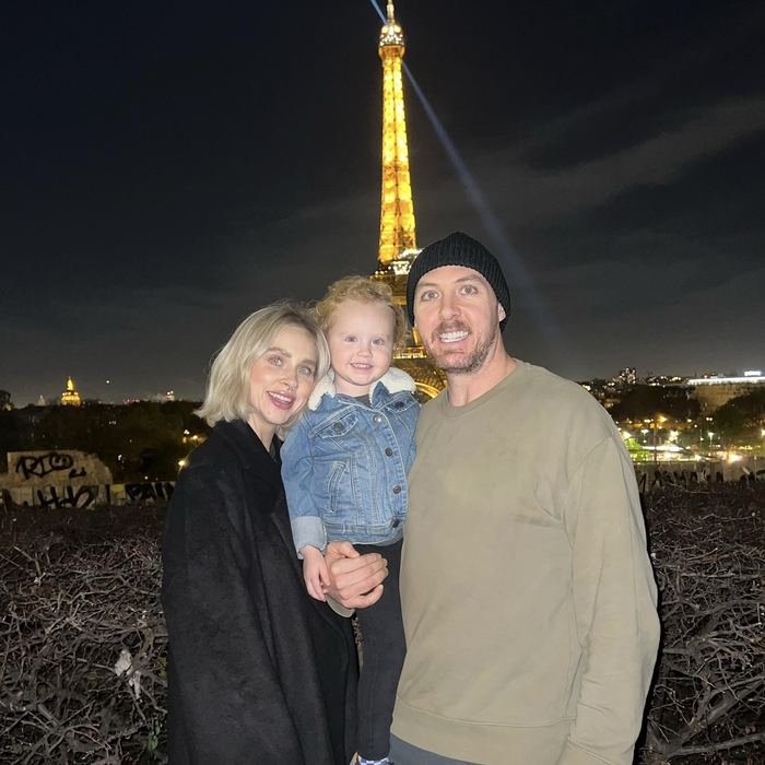 The three of them in front of the Eiffel Tower at night